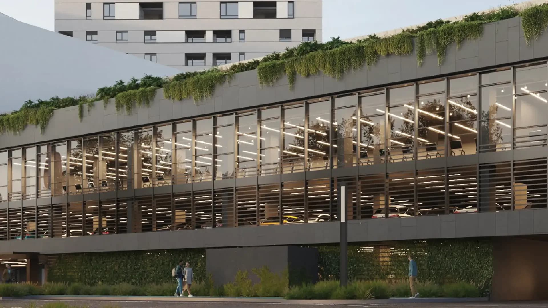 Modern office building with a glass facade and greenery on the roof
